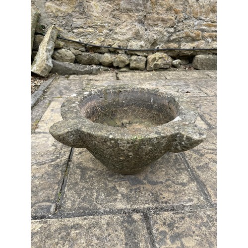 1136 - A large hardstone mortar, 45 cm diameter, a garden table, a set of four stackable chairs, and a trol... 