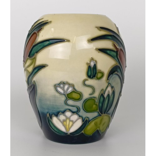 348 - A Moorcroft vase, decorated flowers, 10 cm high, two others, and a Moorcroft box (4)