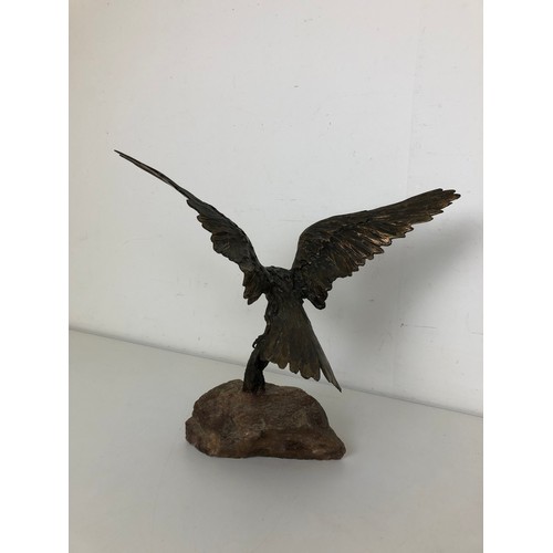 413 - A bronze eagle, on a stone plinth, 40 cm wide