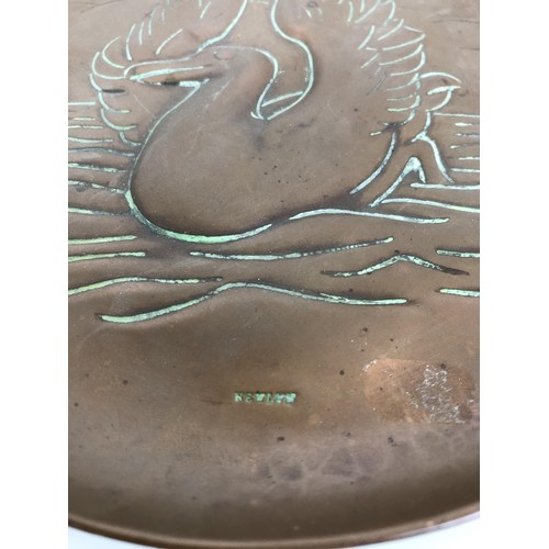 395 - A Newlyn copper dish, decorated a seagull, stamped, 18 cm diameter