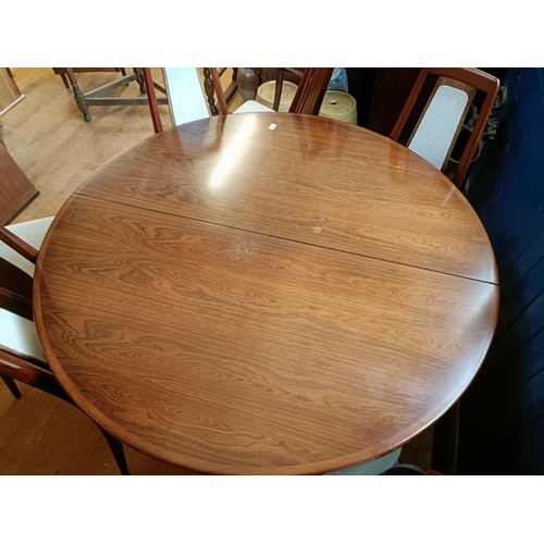 487 - A Danish hardwood extending dining table, 124 cm diameter, with two extra 49 cm leaves, and a set of... 