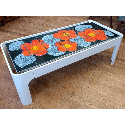 500 - A 1970s tiled top table, decorated flowers, 120 cm wide