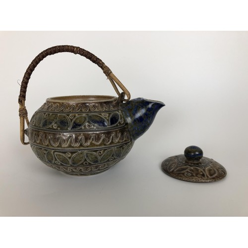 433 - A Martinware style teapot, incised mark to base, 16 cm wide