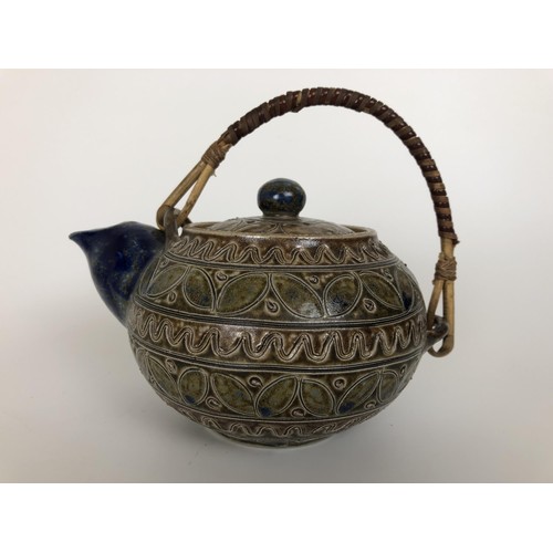 433 - A Martinware style teapot, incised mark to base, 16 cm wide