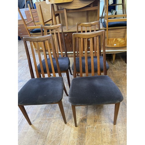 494 - A set of four G-Plan teak dining chairs, and a matching extending dining table, lacking leaves, ... 