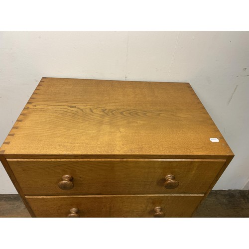 472 - A Cotswold school oak chest, having four drawers, 76  cm wide