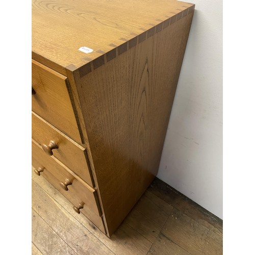 472 - A Cotswold school oak chest, having four drawers, 76  cm wide