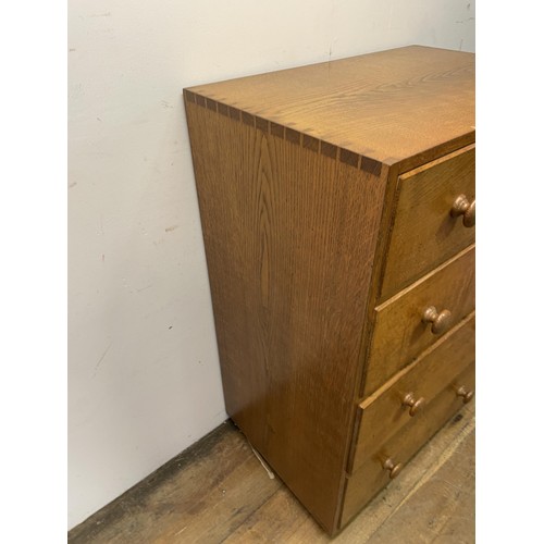 472 - A Cotswold school oak chest, having four drawers, 76  cm wide