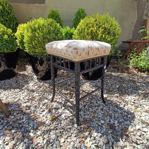 486 - An Arts and Crafts ebonised stool, on turned legs, 36 cm wide