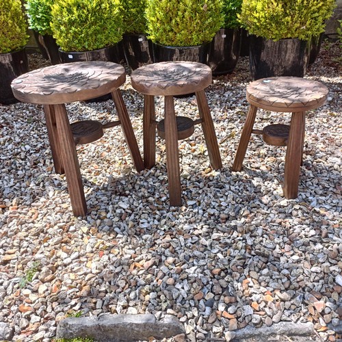 483 - A graduated set of three Liberty & Co style carved oak occasional tables, the largest 40 cm diam... 