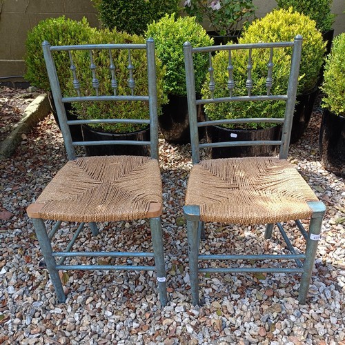 477 - A pair of Arts and Crafts style painted spindle back chairs, with reeded seats (2)