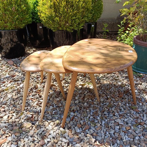 475 - A nest of three Ercol light elm Pebble tables, 65 cm wide