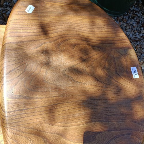 475 - A nest of three Ercol light elm Pebble tables, 65 cm wide