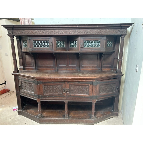 504 - A Liberty & Co large oak dresser, the superstructure with two leaded glazed doors, on a base wit... 