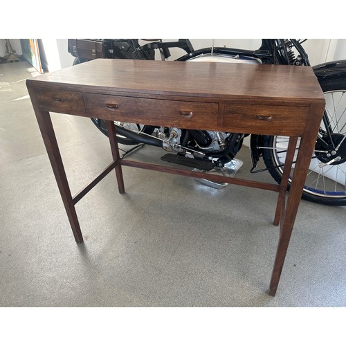 469 - A Cotswold School style walnut bow front table, having three freize drawers on tapering square legs ... 