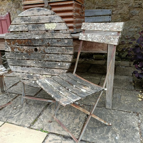 1141 - A weathered pine table, 153 cm wide, a pair of folding chairs, a folding table and a metal trunk (4)... 