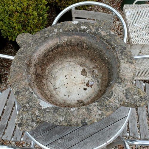 1136 - A large hardstone mortar, 45 cm diameter, a garden table, a set of four stackable chairs, and a trol... 