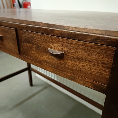 469 - A Cotswold School style walnut bow front table, having three freize drawers on tapering square legs ... 