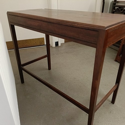 469 - A Cotswold School style walnut bow front table, having three freize drawers on tapering square legs ... 