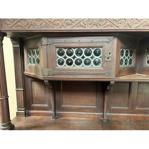 504 - A Liberty & Co large oak dresser, the superstructure with two leaded glazed doors, on a base wit... 