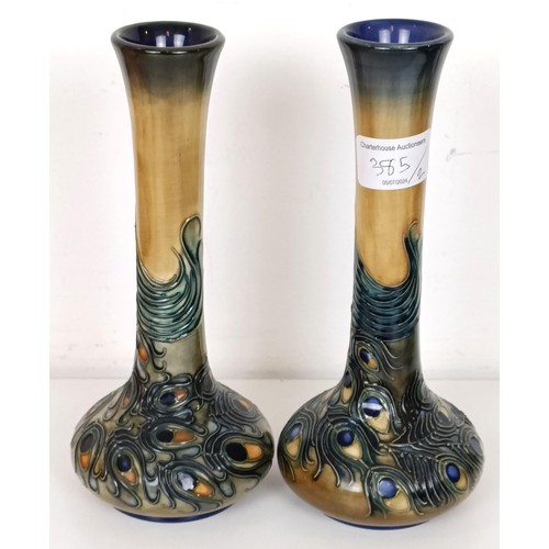 385 - A pair of Moorcroft vases, decorated peacocks, 20 cm high