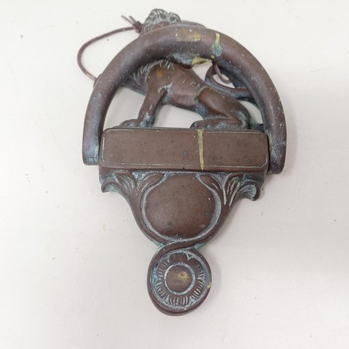 1292 - A bronze door knocker, with a lion finial, 25 cm high