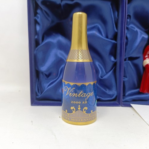 1257 - A Royal Worcester limited edition candle snuffer, in the form of a bottle of champagne, boxed, anoth... 