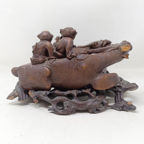 1325 - A pair of Chinese carved hardwood buffaloes, on stands, 24 cm wide