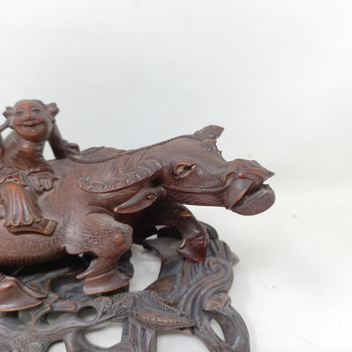 1325 - A pair of Chinese carved hardwood buffaloes, on stands, 24 cm wide