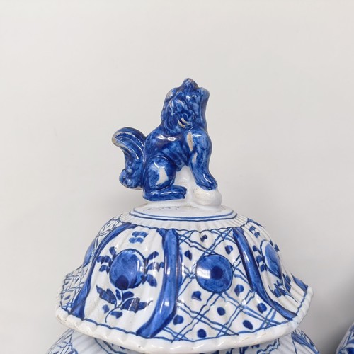 1323 - A pair of Delft blue and white vases and covers, decorated flowers, 34 cm high (2)