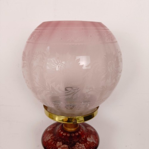 1316 - An oil lamp, with ruby glass base, converted to electricity, 29 cm high