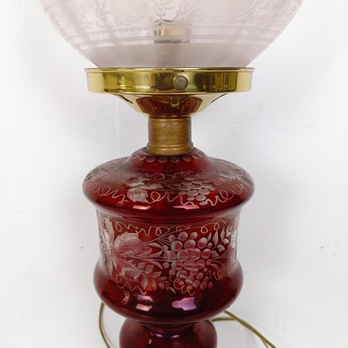 1316 - An oil lamp, with ruby glass base, converted to electricity, 29 cm high