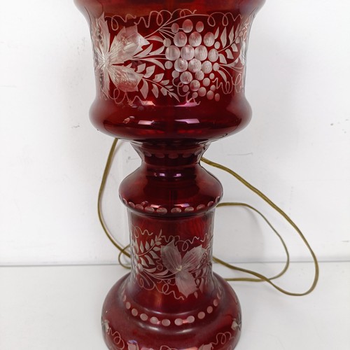 1316 - An oil lamp, with ruby glass base, converted to electricity, 29 cm high