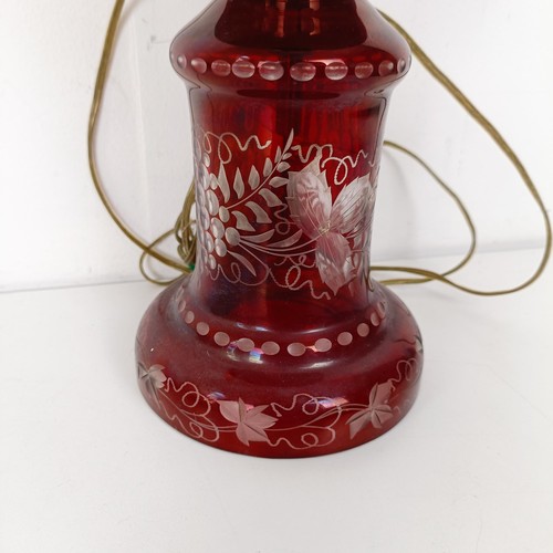 1316 - An oil lamp, with ruby glass base, converted to electricity, 29 cm high