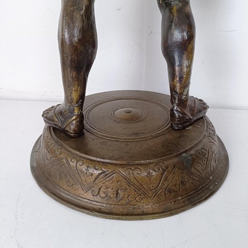 1305 - A Grand Tour style bronze stand, in the form of Bacchus holding a snake, 62 cm high