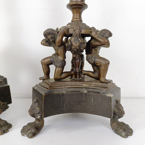 1309 - A pair of bronze figural five branch candelabra, on shaped bases and lion paw feet, 66 cm high