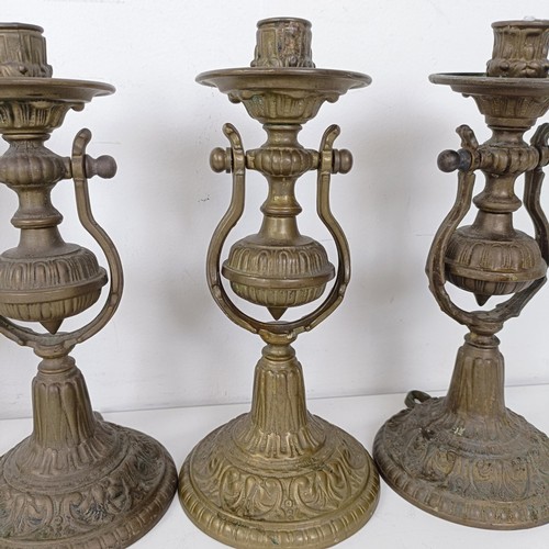 1314 - A set of four brass gimbal wall lights, 25 cm high