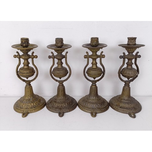 1314 - A set of four brass gimbal wall lights, 25 cm high