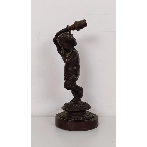 1208 - A bronze lamp base, in the form of a young child, on a circular base, 22 cm high