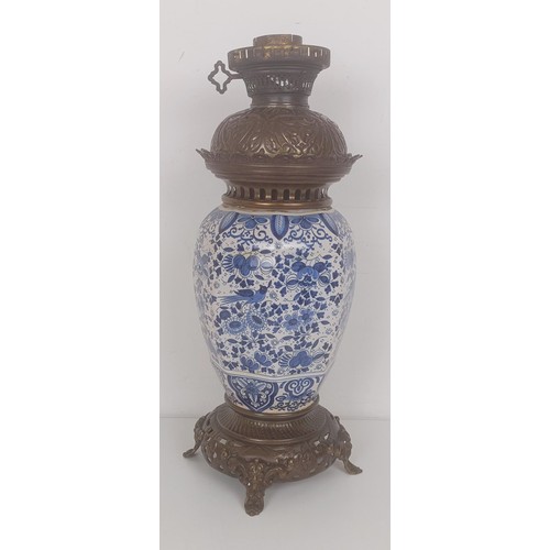 1220 - A Delft oil lamp, with metal mounts, 45 cm