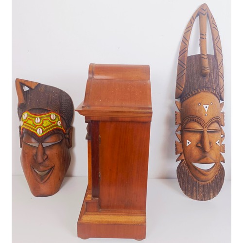 1229 - A mantel clock, in a walnut case, 42 cm high, two African masks, and assorted other items (box)