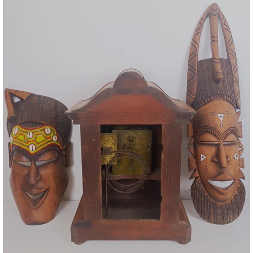 1229 - A mantel clock, in a walnut case, 42 cm high, two African masks, and assorted other items (box)