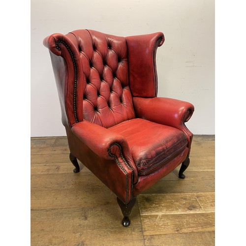 1384 - A red leatherette button back armchair