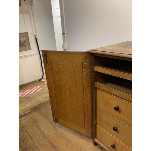 1405 - An oak estate cabinet, the two cupboard doors to reveal two slides and three drawers, 123 cm wide