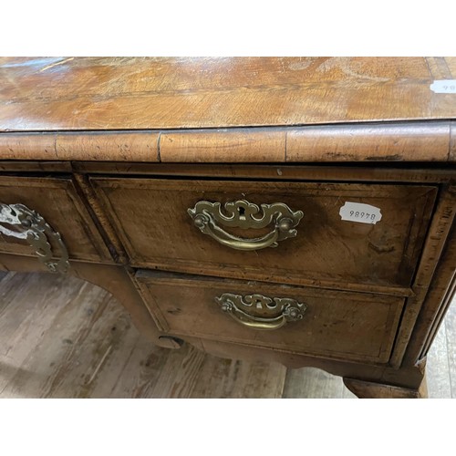 1407 - A walnut dresser base, having five drawers, on carved cabriole legs, 136 cm wide