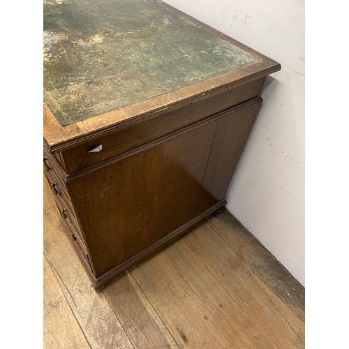 1477 - A mahogany pedestal desk, having a nine drawers, stamped Howard & Son, 125 cm