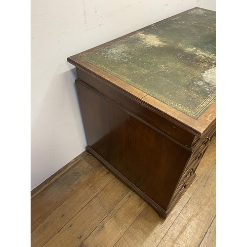 1477 - A mahogany pedestal desk, having a nine drawers, stamped Howard & Son, 125 cm