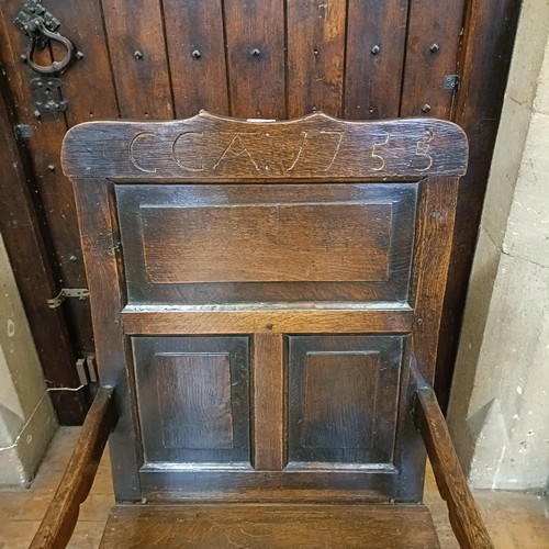 1456 - An oak wainscot type armchair, bearing a date 1755