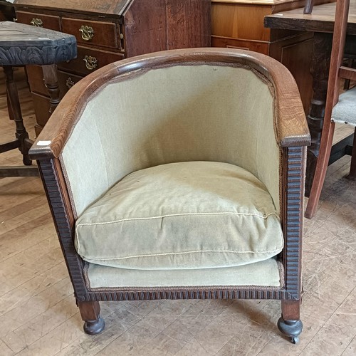 1465 - A carved oak triangular table, an oak tub chair and a sideboard (3)