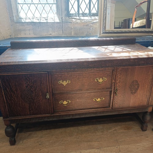 1430 - A set of oak dining chairs, with carved back decorated figures, and an oak sideboard (7)